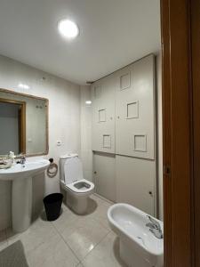 a bathroom with a toilet and a sink at Toto&Koko apartment in Denia