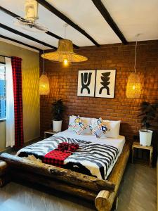 a bedroom with a bed in a brick wall at Swahili Villa in Arusha