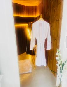 a white coat is hanging in a room at Cabin by the coast in Edinburgh