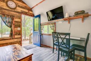 a dining room with a table and chairs and a clock at Inviting Des Arc Cabin with Fire Pit and Deck! in Des Arc +16 photos