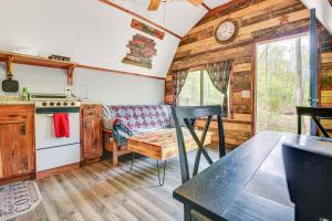 a kitchen with a couch and a table in a room at Inviting Des Arc Cabin with Fire Pit and Deck! in Des Arc
