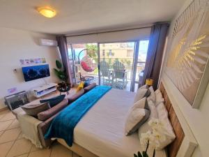 a bedroom with a large bed and a balcony at OCEAN WHISPER II - Power back up, Sea facing, Umdloti in Umdloti