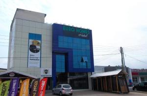 a building with a sign on the side of it at Euro Homes Hotel in Accra