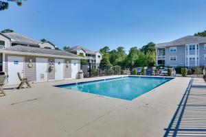 a swimming pool in the courtyard of a home at Southport Fall Getaway | Condo with Deck and Pool in Southport