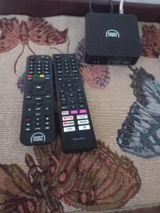 two remote controls sitting on top of a couch at Eloff's Guest House in Polokwane