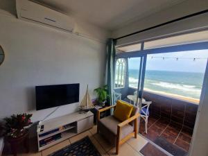 A television and/or entertainment centre at OCEAN GEM - Power back up, Sea facing, Umdloti Resort