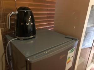 a black appliance sitting on top of a refrigerator at Airbnb at Bailyes in Pretoria