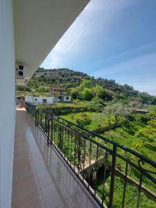 a balcony with a view of a green field at Guest house Irvin in Berat