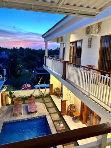 a view from the balcony of a house with a swimming pool at Kailash Villa Balangan in Jimbaran