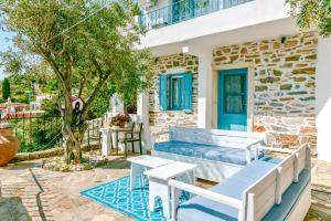 a patio with a blue bench and a table at Patras Apartments in Fourni Ikarias