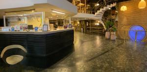 a restaurant with a counter and a bar in a building at Regente Palace Hotel in Buenos Aires