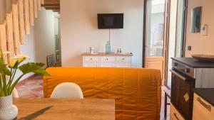 un soggiorno con divano giallo e tavolo di Welcomely - Domo Mea Apartment a Càbras