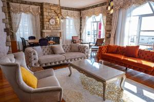 a living room with couches and a coffee table at Fener burnunda Denize sıfır orjinaltaş malikane in Çeşme