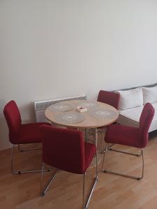 a table and chairs with a couch in a room at Apartman Čerkez in Stolac
