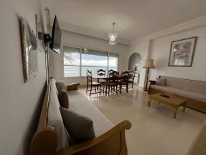 a living room with a couch and a table at Mahdia vue sur mer 2 in Hiboun