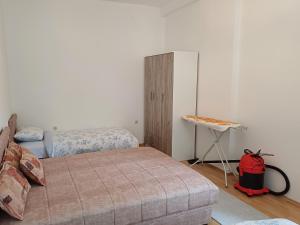 um quarto com 2 camas e uma mesa com uma mochila vermelha em Apartman Čerkez em Stolac