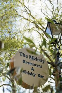 a sign for the melody restaurant and whiskey bar at St Paul's Hotel in London