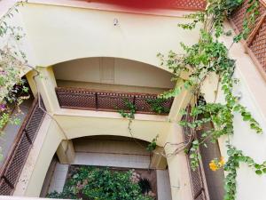 a building with a balcony with plants on it at Marina Cozy Djerba in Houmt Souk