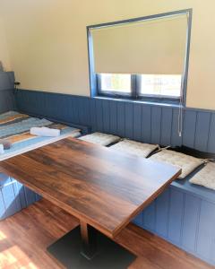 a conference room with a wooden table and a window at Tinyhaus Löwenzahn in Rheinsberg