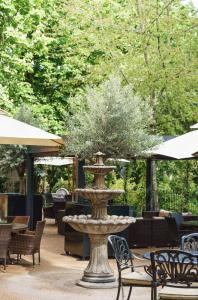 a fountain with a tree in it in a patio at St Paul's Hotel in London
