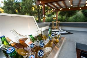a bunch of bottles of beer sitting on a bar at Serene Vineyard Chateau with Pool, Hot Tub, BBQ in Carmel Valley