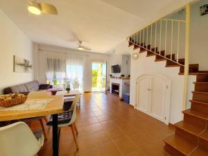a living room with a table and a dining room at ALBATROS GOLF - ISLANTILLA in Islantilla