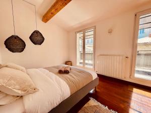 a bedroom with a bed with two shoes on it at Sublime maison de Ville pour 6Pers, 2 chambres, au calme absolu in Marseille