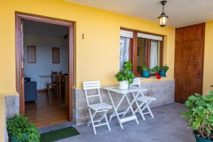 une terrasse avec une table et des chaises devant une maison dans l'établissement APARTAMENTOS OLGA, à Cudillero