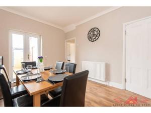 a dining room with a table with computers on it at 3BR House in Darlington - Near Airport FREE Parking in Darlington