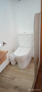 a white bathroom with a toilet and a sink at Habitaciones y Suite. UPV, UV y Playa in Valencia