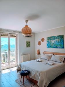a bedroom with a large bed and a large window at Villa Artemis in Graniti