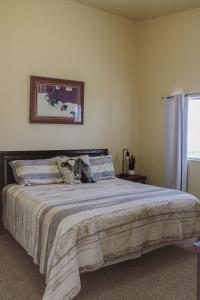 a bedroom with a large bed with a blanket at Chic Residence Near DT Sheridan in Sheridan