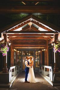 Braut und Bräutigam küssen sich vor einem Gebäude in der Unterkunft Hidden Valley Resort, Ascend Hotel Collection in Huntsville
