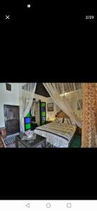 a picture of a bedroom with two beds with mosquito nets at One bedroom apartement with enclosed garden and wifi at Fes El Bali Fes in Fez