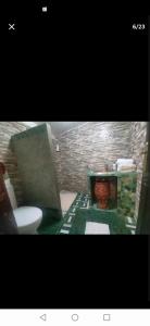 a bathroom with a toilet and a table with a sink at One bedroom apartement with enclosed garden and wifi at Fes El Bali Fes in Fez