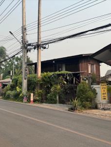 an empty street in front of a building at Imchai in Pai