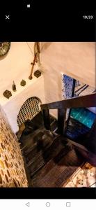 a picture of a staircase in a room with a table at One bedroom apartement with enclosed garden and wifi at Fes El Bali Fes in Fez