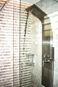a shower with a glass door next to a staircase at Filia's Countryside House in Chania Town