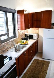 a small kitchen with a sink and a microwave at Filia's Countryside House in Chania Town