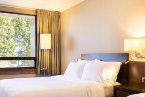 a hotel room with a bed and a window at Holiday Inn Express - Temuco, an IHG Hotel in Temuco
