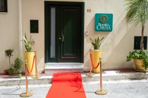 a red carpet in front of a house with a door at Borgo La Chiusa in Cinisi