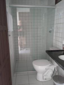 a man taking a picture of a bathroom with a toilet at Sereia do Mar Pousada e Restaurante Ltda in Jacumã +51 photos