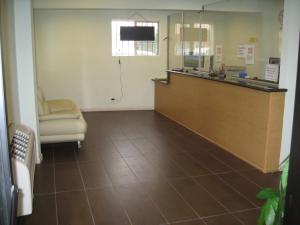a hospital room with a reception desk and a chair at Eastsider Motel -Downtown LA in Los Angeles