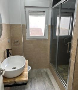 a bathroom with a sink and a shower at Pinos del Mar in Huelva