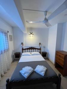 a bedroom with a bed with two white pillows at Hotel Garay in San Bernardo