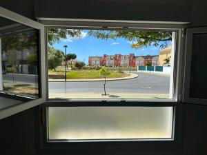 a window with a view of a street outside at Pinos del Mar in Huelva