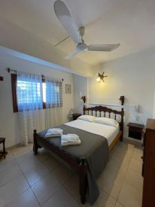 a bedroom with a bed and a ceiling fan at Hotel Garay in San Bernardo