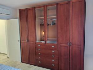a wooden cabinet with glass doors in a room at Pinos del Mar in Huelva