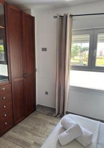 a bedroom with a bed and a dresser and a window at Pinos del Mar in Huelva