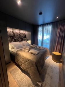 a bedroom with a large bed with towels on it at Snowbird Villas (Arctic Nook) in Kittilä